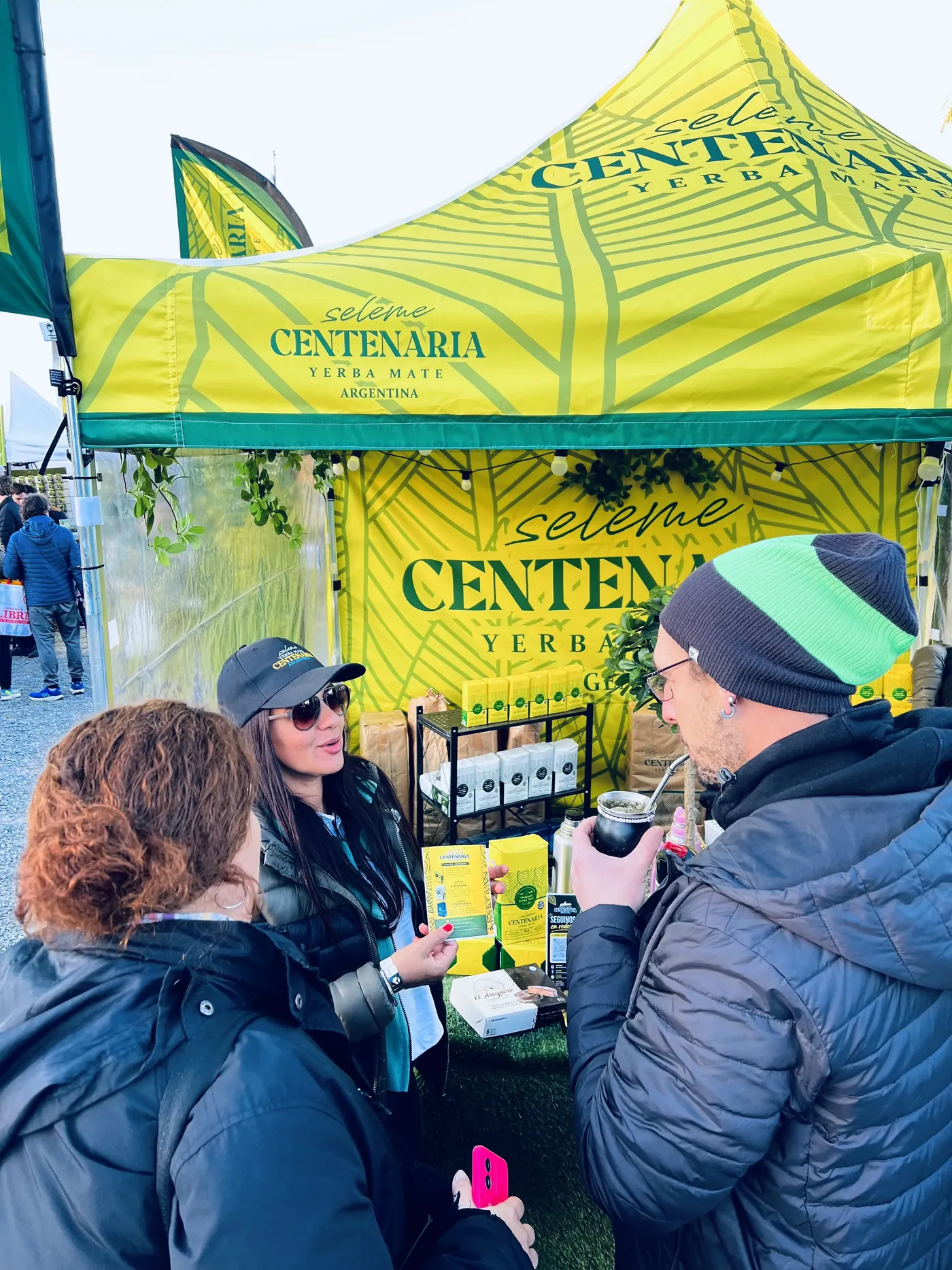 Gazebo de Seleme Centenaria en una feria, con gente tomando mate